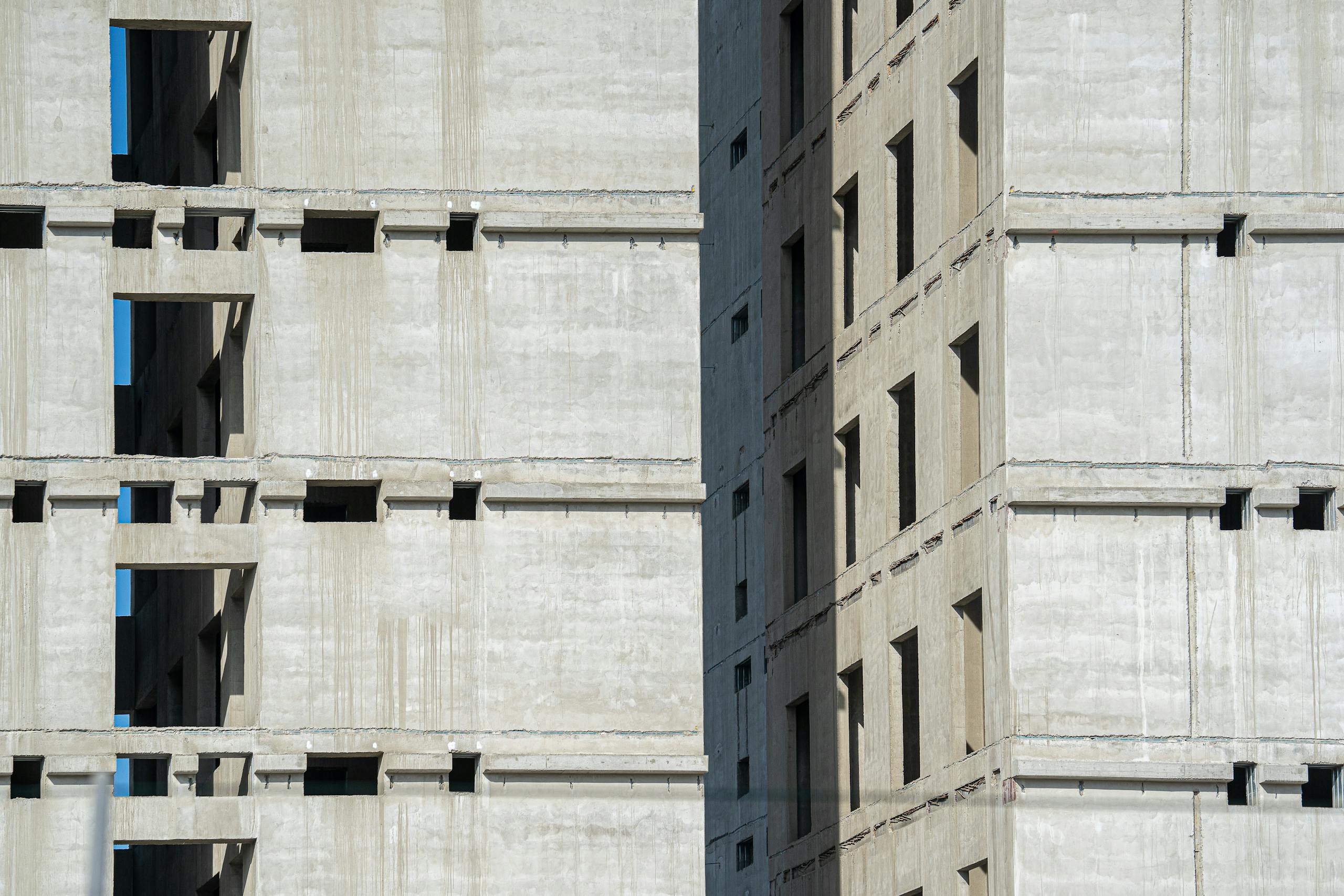 Close-up of an unfinished high-rise building with concrete structure.